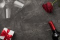 Top view photo of st valentine`s day decorations two wineglasses wine bottle white giftbox with red bow and red rose on isolated