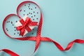 Top view photo of st valentine`s day decorations white gift box with red bow in red satin ribbon heart and heart shaped confetti Royalty Free Stock Photo