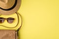 Top view photo of sunhat sunglasses and leather bag on isolated yellow background with copyspace