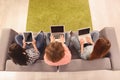 Top view photo of three girls working on laptop and digital tablet Royalty Free Stock Photo