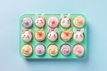 Top view photo of a tray of Easter cupcakes decorated with pastel-colored frosting