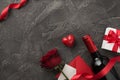 Top view photo of valentine`s day decor wine bottle white giftbox with red bow curly ribbon heart envelope with card and red rose Royalty Free Stock Photo