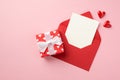 Top view photo of valentine`s day decorations small hearts giftbox in red wrapping paper with pattern of hearts and bow open red Royalty Free Stock Photo