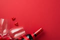 Top view photo of valentine`s day decorations small hearts between two wineglasses wine bottle on isolated red background with