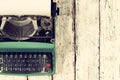 Top view photo of vintage typewriter with blank page, on wooden table. retro filtered image