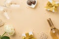 Top view photo of white gift boxes with bows wineglasses wine bottle golden sequins rattan hearts heart shaped saucer with candies