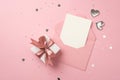 Top view photo of white giftbox with pink ribbon bow silver hearts open pink envelope with card heart shaped confetti and shiny Royalty Free Stock Photo