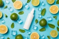 Top view photo of white spray bottle without label in the middle mint leaves whole and sliced limes cut lemon ice cubes and water Royalty Free Stock Photo