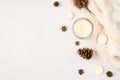 Top view photo of winter composition lighted candles white knitted scarf pine cones and anise on isolated white background with