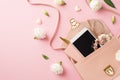 Top view photo of woman`s day composition open pink leather bag with smartphone scrunchies glasses pen small hearts and prairie Royalty Free Stock Photo