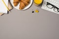 Top view photo of workplace keyboard glasses binder clips notepads pencil glass of juice and plate with fresh croissants on