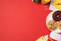 Top view photo of workspace keyboard mouse yellow sticky note paper clips flowerpot red pencil reminders glass of juice and plate Royalty Free Stock Photo