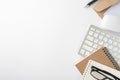 Top view photo of workstation keyboard computer mouse reminders glasses pen and envelope with paper sheet on isolated white