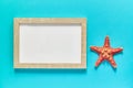 Top view of photoframe with seashells and starfish on blue background. Summer vacation concept. Sea flat lay Royalty Free Stock Photo