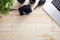 Top view of photographer desk with latptop, camera and lenses. Flat lay shot on wooden desk Royalty Free Stock Photo