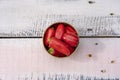 Top view photography of handful of small red bell peppers on pastel painted wood