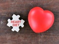 Top view phrase heart diet on wooden jigsaw puzzle with red heart shape on the table.