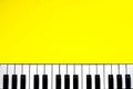 Top view piano keys over yellow background. Pianist musician, pianist concept. Music Keyboard. Copy space