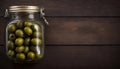 Top View of Pickled Olives in Jar on Wooden Table, Copy Space