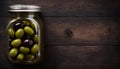 Top View of Pickled Olives in Jar on Wooden Table, Copy Space