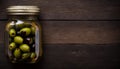 Top View of Pickled Olives in Jar on Wooden Table, Copy Space