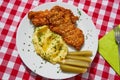 Top view picture on the deep fried chicken escalope or schnitzel with mashed potatoes and pickled cucumbers. Royalty Free Stock Photo