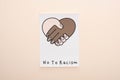 Top view of picture with multiethnic handshake and no to racism lettering