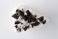 Top view of piece of biscuit cale with chocolate cookie crumbs on the white surface Royalty Free Stock Photo