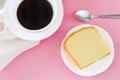 Top view piece of butter cake on white dish served with cup of black coffee, metal spoon. Times to relax concept. Royalty Free Stock Photo