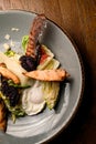 top view of a piece of fried chicken and bacon in salad. Cropped photo.