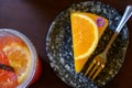 Top View of a piece of orange cake and sliced orange topping with spoon. Cake with orange mousse with copy space