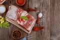 Top view of piece of raw pork belly with salt and red paprika on wooden table Royalty Free Stock Photo