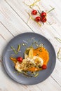 Top view pike perch fillet with creamy pumpkin puree and seeds, almond flakes, fried cherry tomatoes and thyme, lunch menu of