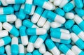 Top view pile of blue and white antibiotic capsule pills texture. Pharmaceutical production. Global healthcare. Antibiotics drug