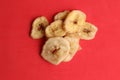 Top view of a pile of dried banana slices on a red background Royalty Free Stock Photo