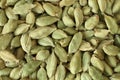 Top view on a pile of dry scattered unrefined cardamom seeds