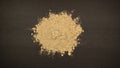 TOP VIEW: Pile of ginger powder on a black table