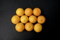 Top view of a pile of orange tangerine on a black background