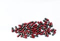 Top view pile of red and grey capsule pills isolated on white background with copy space. Flunarizine : drug for migraine Royalty Free Stock Photo