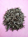 Top view of a pile of shoe nails on a pink surface Royalty Free Stock Photo