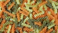 Top view of the pile of spiral shaped three-color fusilli pasta for background or wallpaper Royalty Free Stock Photo