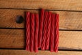 Top view of a pile of sweet red licorice on a wooden surface