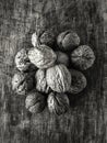 Top view on pile of walnuts lying on a scratched wooden cut Royalty Free Stock Photo