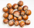 Top view of pile of whole hazelnuts on gray