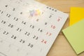 Top view. pin putting on desktop calendar and have post-it note Royalty Free Stock Photo