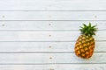 Top view pineapple on blue wooden background with copy space for summer holiday and vacation concept.