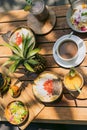 top view of pineapple, delicious tropical cocktails and snacks on wooden table