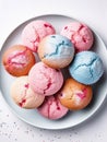 Top view of pink and blue cupcakes on a plate.