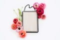 top view of pink flowers and black elegant empty frame over white background. For mock up, copy space Royalty Free Stock Photo