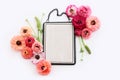 top view of pink flowers and black elegant empty frame over white background. For mock up, copy space Royalty Free Stock Photo